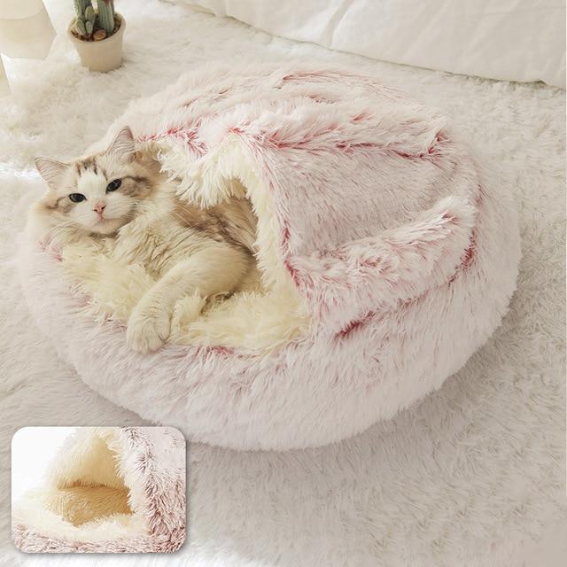 Cat resting in a pink latte calming pet bed