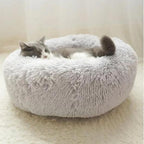 Grey donut pet bed with a raised padded rim