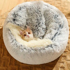 Cat resting inside a cosy grey calming pet bed