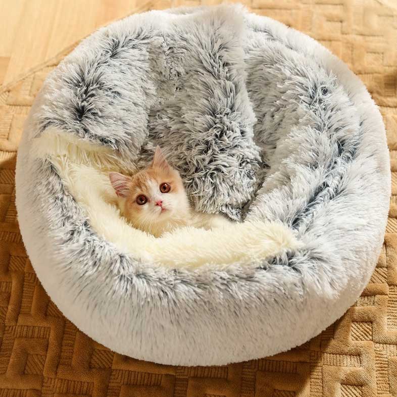 Cat resting inside a cosy grey calming pet bed